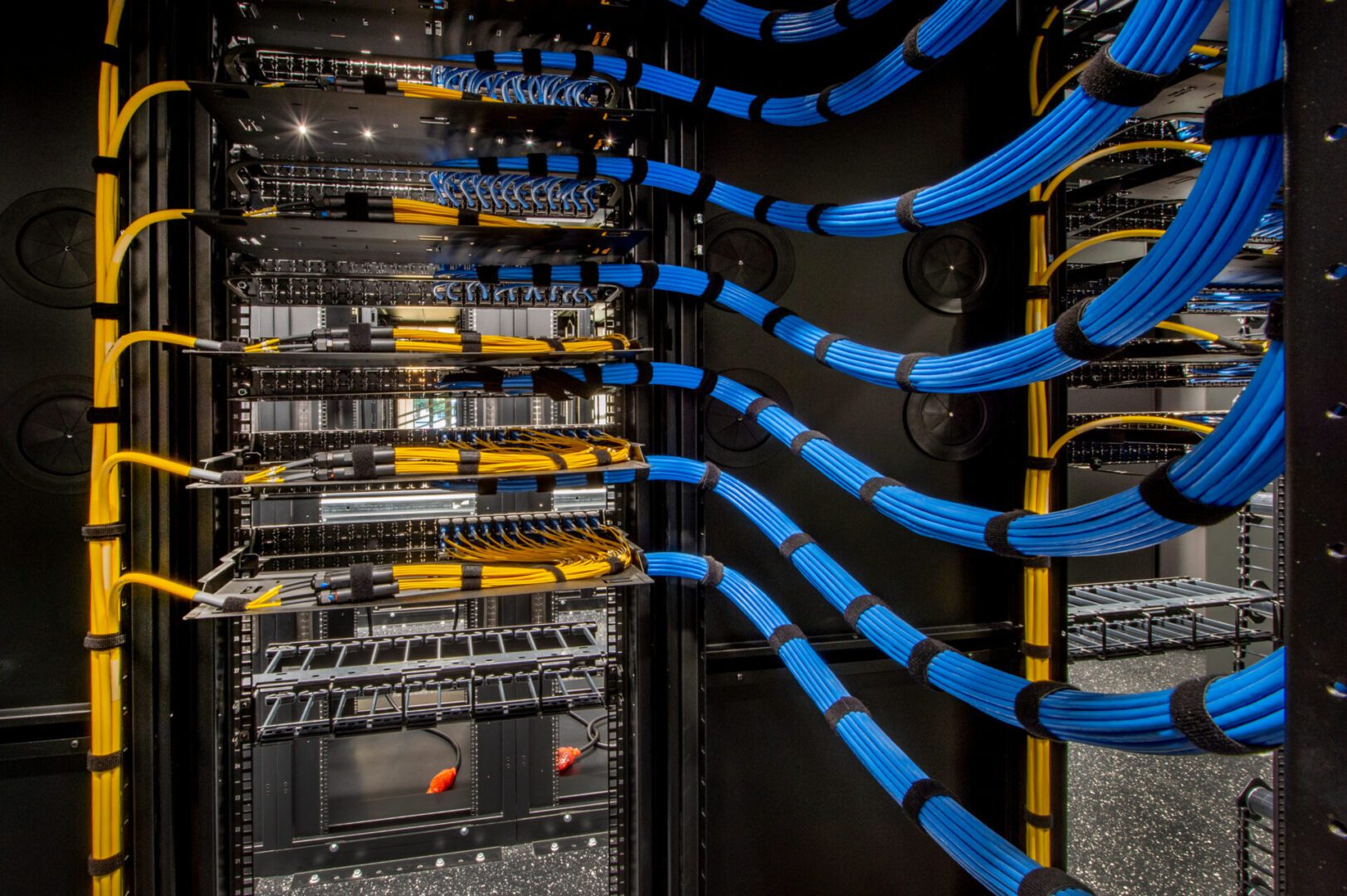Server room with organized blue network cables.